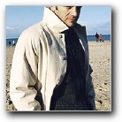 Samuel On The Beach In An Overcoat